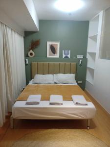 a bedroom with a large bed with two towels on it at 2 Bedrooms Units Forbes Area 5th Avenue BGC Center in Manila +162 photos