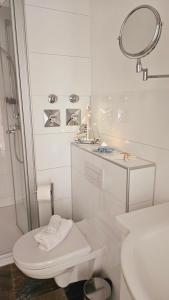 biała łazienka z toaletą i prysznicem w obiekcie ٤Neu٤Fantastischer Meerblick-Stylish-King Bed-PP w mieście Scharbeutz