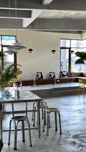 a dining room with a table and chairs and windows at Centerpoint Hotel & Plaza in Thongsala