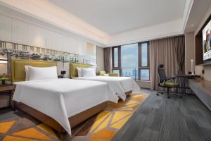 Postel nebo postele na pokoji v ubytování Hampton by Hilton Guangzhou Luoxi
