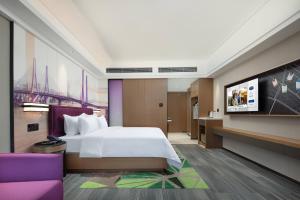 Postel nebo postele na pokoji v ubytování Hampton by Hilton Guangzhou Luoxi