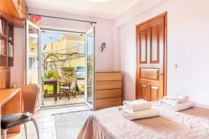 a bedroom with a bed with towels on it at Ilios Country house in Arillas