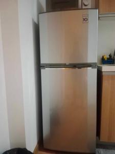 a stainless steel refrigerator in the corner of a kitchen at AZURE HOTEL RESORT Ph15 St Tropez in Manila