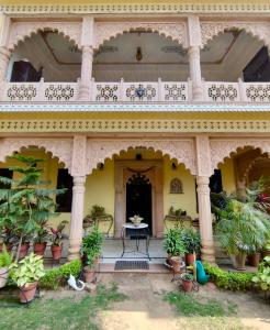 an ornate building with a table and potted plants at The Kunadi Heritage by Boho Stays in Jaipur