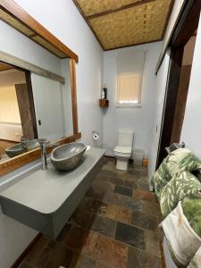 a bathroom with a sink and a toilet at Aloegrove Safari Lodge in Otjiwarongo
