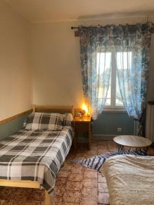a bedroom with two beds and a window at Coup de cœur en Brenne in Martizay