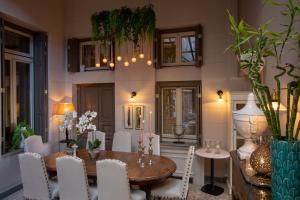 a dining room with a wooden table and white chairs at Marpessa Hotel & Spa in Agrinion