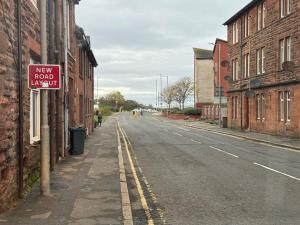 an empty street with a new roadlaw sign on a building at Barassie, Troon in Troon