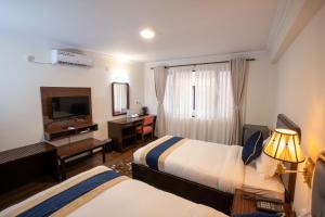 Letto o letti in una camera di Kathmandu Business Hotel