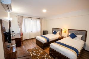 Letto o letti in una camera di Kathmandu Business Hotel
