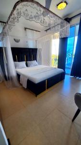 una camera con un grande letto a baldacchino di Ulah Properties a Mombasa