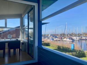 a view of a marina from the window of a house at 6pers. Lauwersmeer Lakefront. Nirvana house with sauna, pellet stove in Anjum