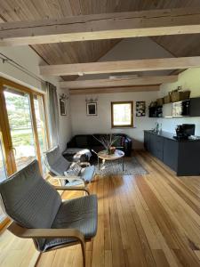 a living room with two chairs and a couch at Holiday home Slokas in Vecumnieki