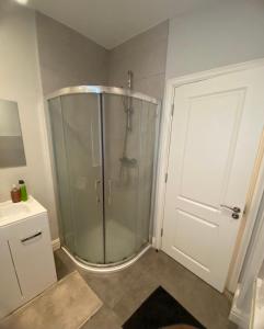 a shower with a glass door in a bathroom at Extra large Room in new house at Citywest in Dublin