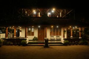 a house lit up at night with lights at Mi Casa Tu Casa Homestay in Cochin