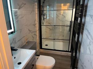 a bathroom with a shower and a toilet and a sink at Barassie, Troon in Troon