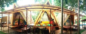 a small wooden tent with a table in it at ALCAVA Rustic Kubo Huts in Dipolog
