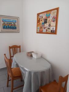 a dining room table with a white table cloth on it at Casa Surunova in Naples