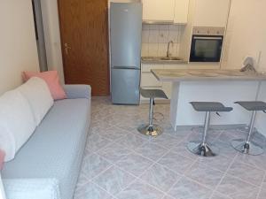 a living room with a couch and a kitchen at Apartment Novaković in Mirce