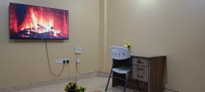 a living room with a chair and a fireplace at Siwarani Cozy Two bedroom,Kamakis Eastern Bypass Ruiru in Ruiru