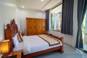 Postel nebo postele na pokoji v ubytování Dieu Thong Hotel