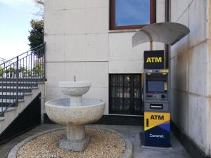 a parking meter next to a fountain in front of a building at Hotel La Fontana in Stresa
