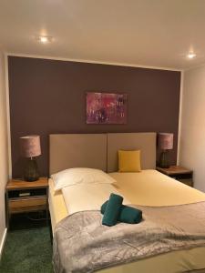 a bedroom with a bed with two pillows on it at BESOTEL Erkrath- Ferienwohnungen und Apartments in Erkrath