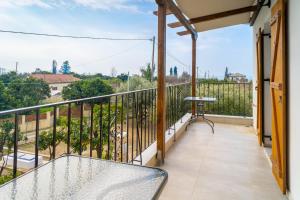 a balcony with a table and a view at Kostis Orange Resort in Volos