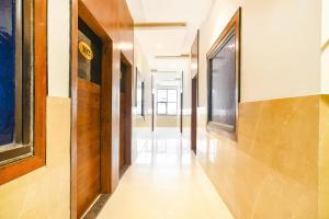 a hallway of a building with wooden walls and floors and a hallway at FabHotel Aashiyana in Indore