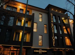 a building with a sign that reads the amazon collective at RIVA Boutique Hotel in Szeged