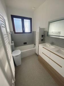 ein Badezimmer mit einer Badewanne, einem WC und einem Waschbecken in der Unterkunft Villa 4* Proche centre et plage. Animaux bienvenus in Meschers-sur-Gironde