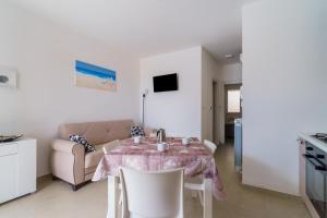 ein Wohnzimmer mit einem Tisch und einem Sofa in der Unterkunft Casa d'a mare in Torre San Giovanni Ugento