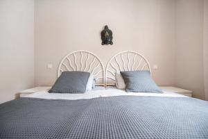 a bedroom with a large bed with two pillows at Casa Weimar in Costa Calma