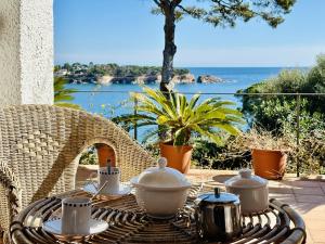 a rattan table with a tea set on top at Maset CostaBravaSi in Sant Feliu de Guixols