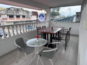 a table and chairs on the balcony of a restaurant at Dsney Boutique Hotel in Melaka