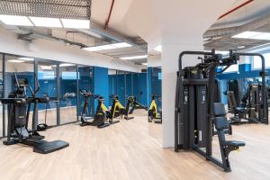a gym with treadmills and elliptical machines at Ripamonti Milan Porta Romana Cosy vibes and modern rooms right around the city centre in Milan