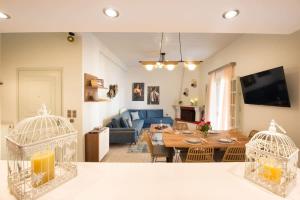 uma sala de estar com um sofá azul e uma mesa em Dolce Favola Nomad Casa - Kalamata's City Getaway em Kalamata