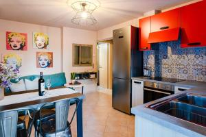 a kitchen with red cabinets and a counter top at Urban Living, Minicasa Nomad - Kalamata's Hideaway in Akovítika