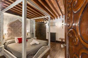 a bedroom with a large bed with a wooden headboard at Casa catedral in Murcia