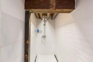 a bathroom with a shower with white tiles at Casa catedral II in Murcia