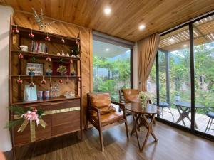 a dining room with a table and a room with a window at Sóc Sơn - Bird House in Sóc Sơn