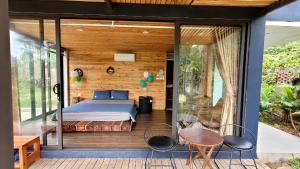 a bedroom in a house with a bed on a deck at Sóc Sơn - Bird House in Sóc Sơn