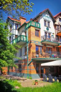 a large building with balconies on the side of it at Willa Amor in Krynica Morska