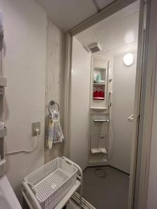 a small bathroom with a walk in shower and a refrigerator at 幸・3 in Osaka +48 photos