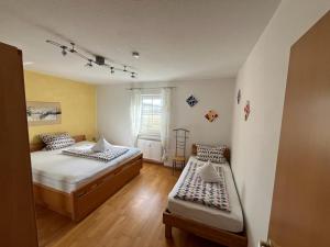a bedroom with two beds and a window at Ferienwohnung Schneider in Ruhstorf +6 photos