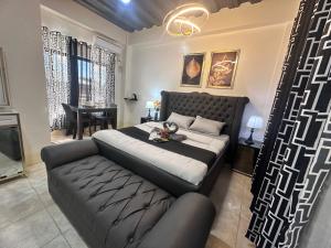 a bedroom with a large bed and a couch at Golden Dreams Lodging Home in Camalaniugan