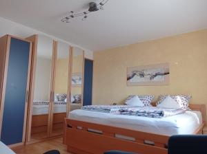 a bedroom with a bed with blue walls at Ferienwohnung Schneider in Ruhstorf
