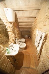 a bathroom with a sink and a toilet and a mirror at La Macina in Cetona