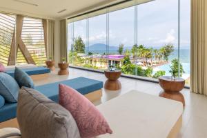 a living room with a view of the ocean at TTC Van Phong Bay Resort - Himalaya Sauna & Steam Retreat Included in Ninh Hòa