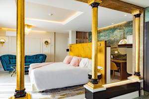 a bedroom with a white bed and a painting at Hotel Boutique Cortijo Landete - SOLO ADULTOS in Granada